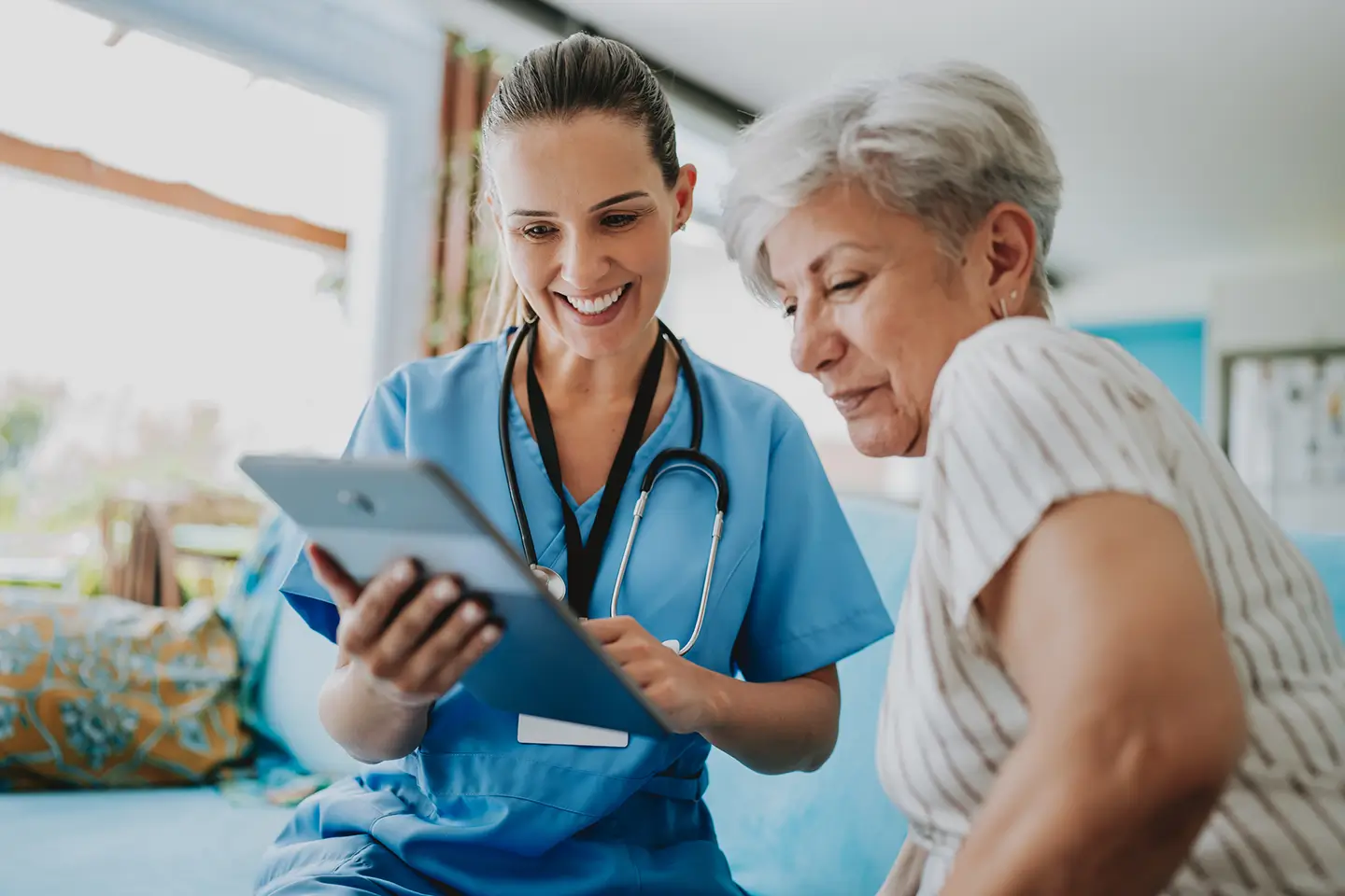 Post surgery caregiver assisting an older woman