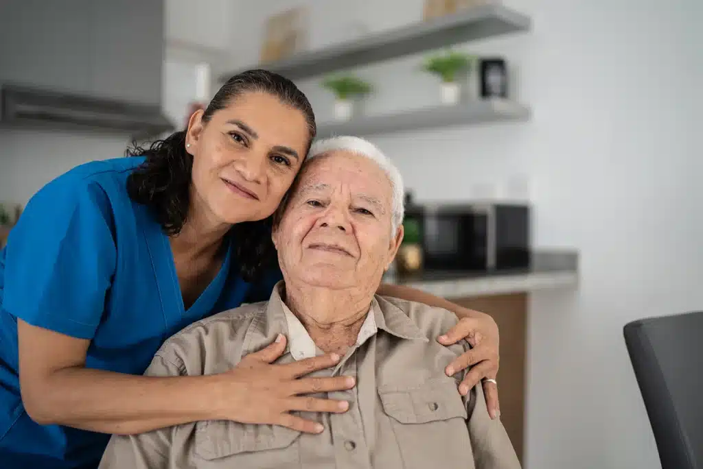 Caregiver supporting an older adult with person-centred memory care services at home